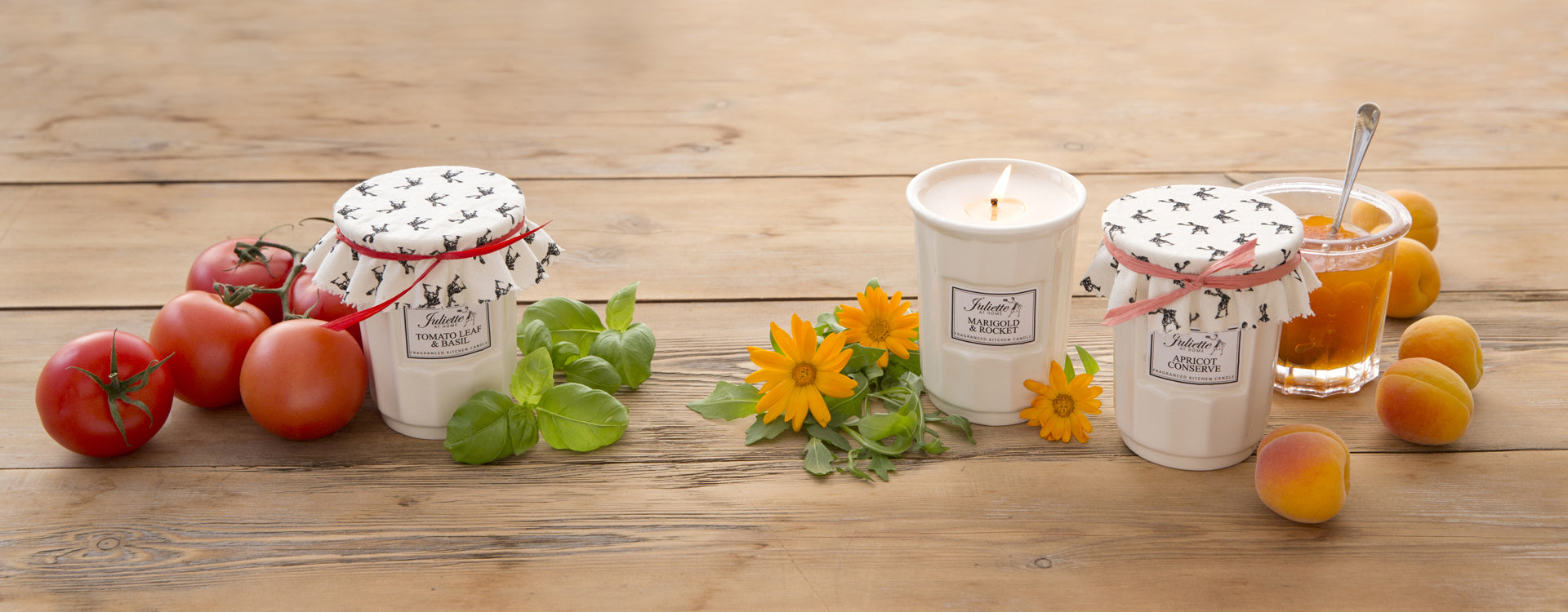 A selection of Juliette at Home candles on a wooden background